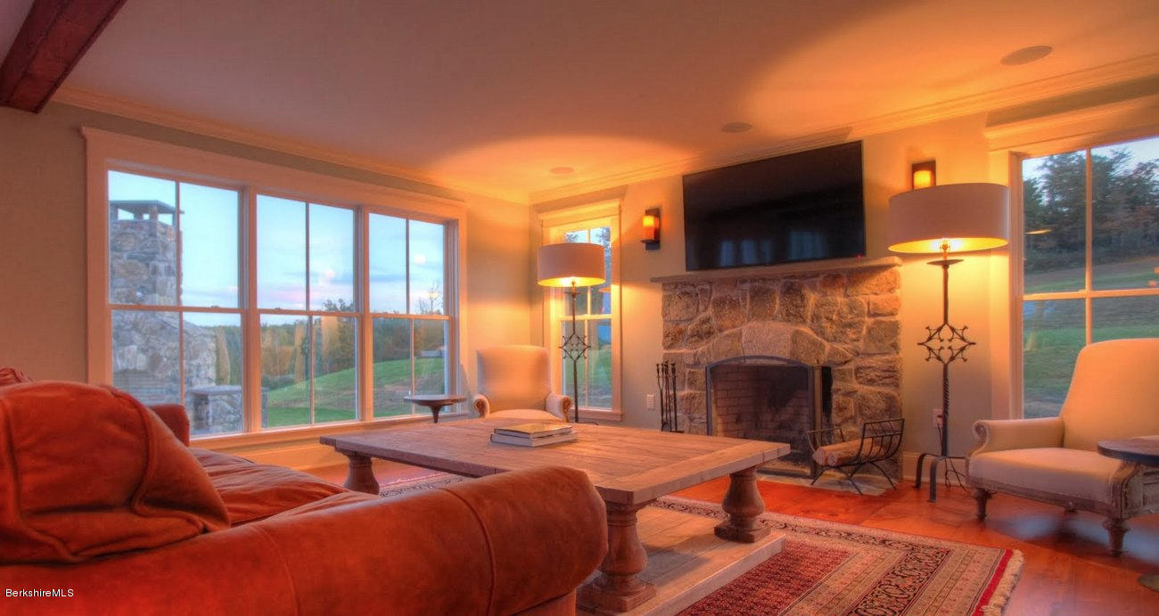 40 Viets Road Sandisfield, MA 01255 - Photo 61 of 92 a bedroom with furniture a fireplace and a flat screen tv
