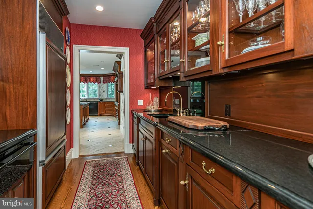 a kitchen with granite countertop sink and cabinets