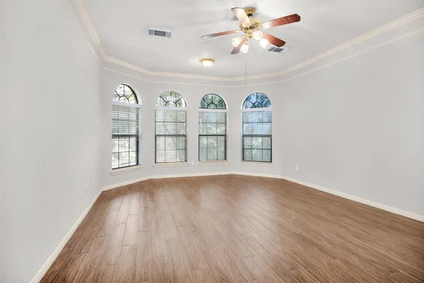 wooden floor in an empty room with a window