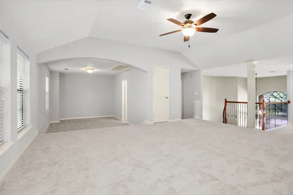 an empty room with windows and closet