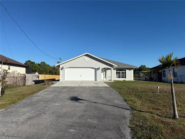 a big house with a big yard and large trees
