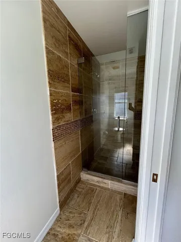 a bathroom with a glass shower door