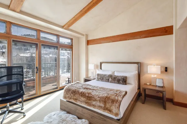 a bedroom with a large bed and a night stand