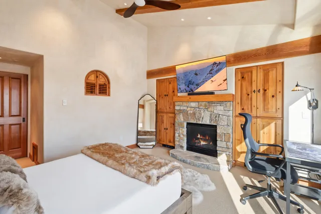 a bedroom with a bed and a fireplace