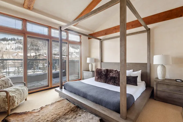 a bedroom with a large bed and a large window