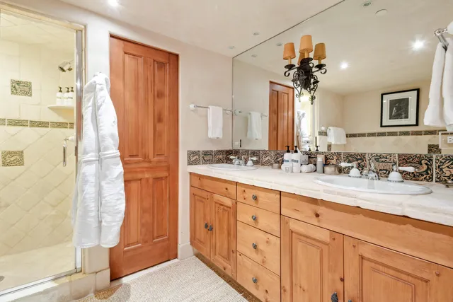 a bathroom with a double vanity sink a and a mirror
