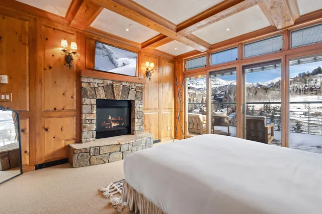 a bedroom with a bed and a fireplace