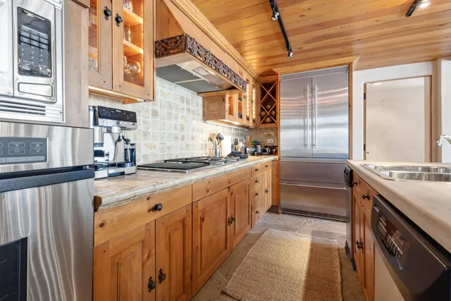 a kitchen with stainless steel appliances a sink and cabinets