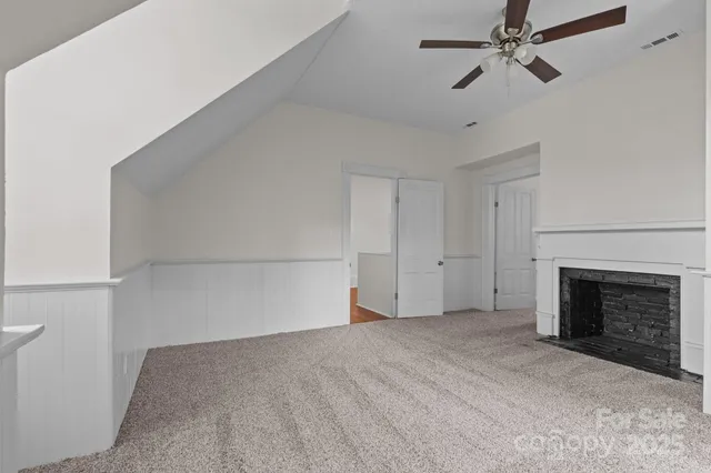 a view of an empty room with a fireplace