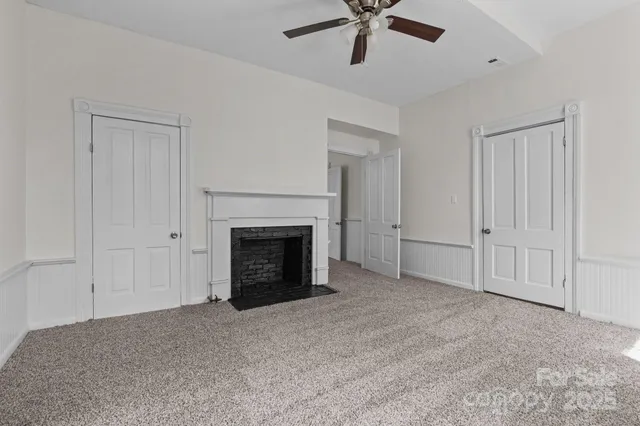 a view of an empty room with a fireplace