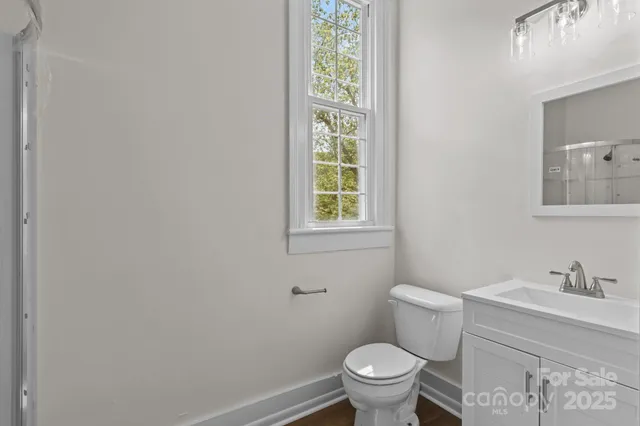 a white toilet sitting next to a bathroom sink