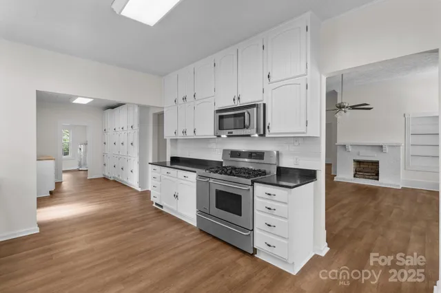 a kitchen with stainless steel appliances a white stove top oven and a refrigerator