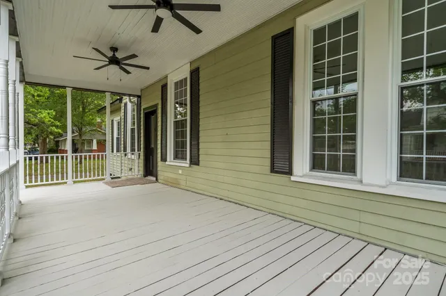 a view of a balcony with a ceiling fan and wooden floor