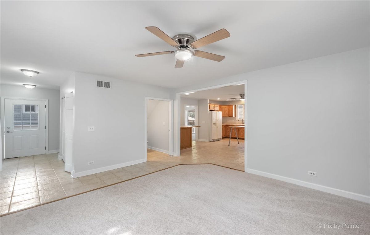 30 Crissey Avenue Geneva, IL 60134 - Photo 15 of 48 a view of a livingroom with a ceiling fan & windows