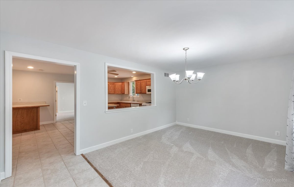 30 Crissey Avenue Geneva, IL 60134 - Photo 4 of 48 an empty room with chandelier and windows