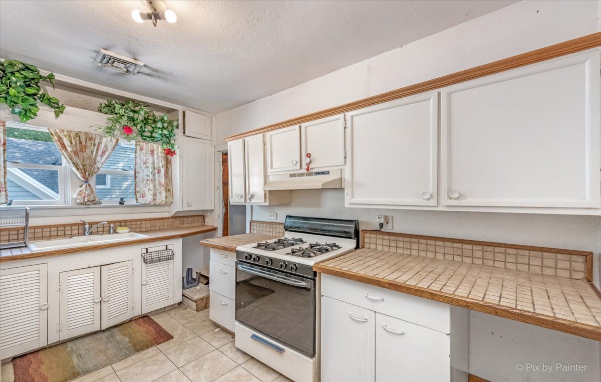 30 Crissey Avenue Geneva, IL 60134 - Photo 33 of 48 a kitchen with white cabinets and appliances