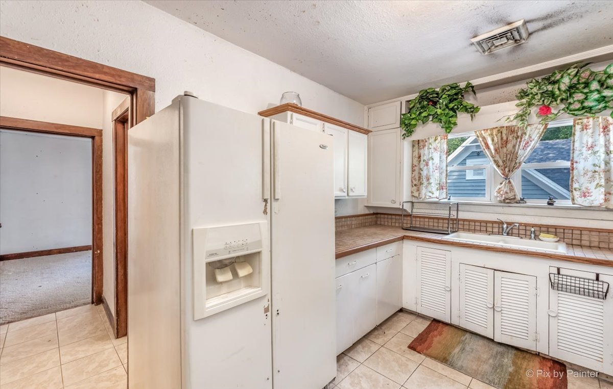 30 Crissey Avenue Geneva, IL 60134 - Photo 34 of 48 a kitchen with a refrigerator a sink and cabinets