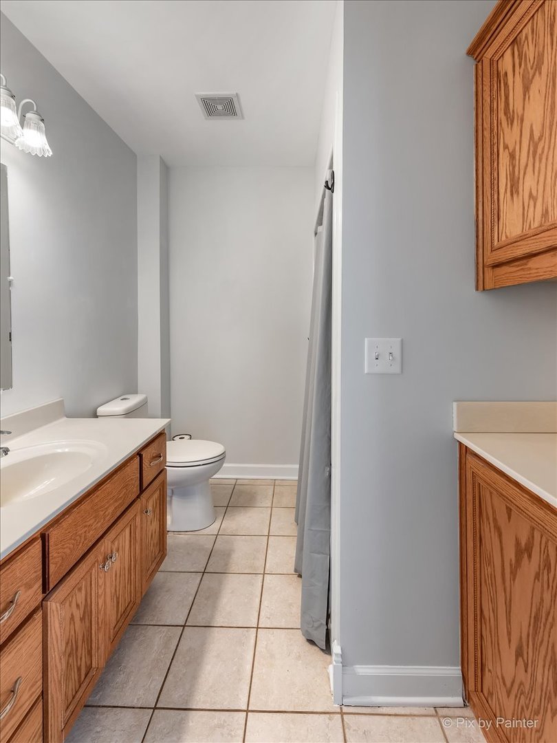 30 Crissey Avenue Geneva, IL 60134 - Photo 7 of 48 a spacious bathroom with a granite countertop sink a toilet and a mirror