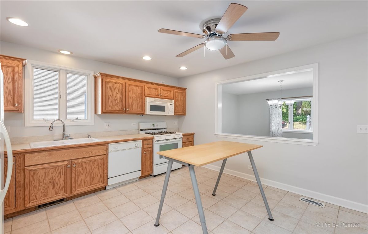 30 Crissey Avenue Geneva, IL 60134 - Photo 9 of 48 a kitchen with a sink chairs and window