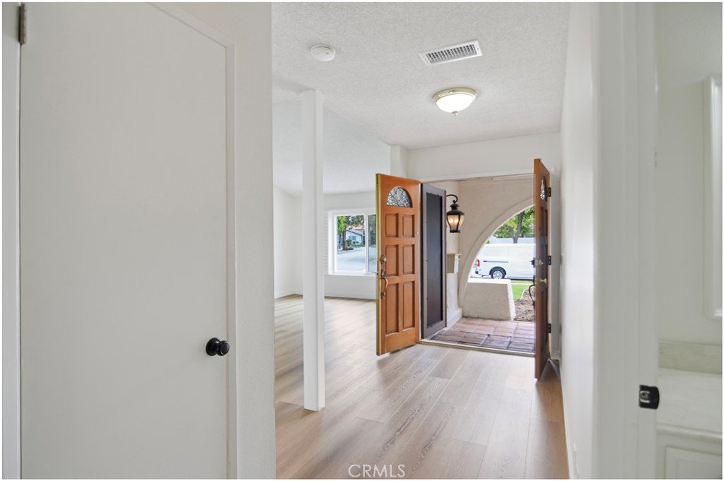 1110 Redding Avenue Costa Mesa, CA 92626 - Photo 12 of 30 a view of a hallway with wooden floor and closet area
