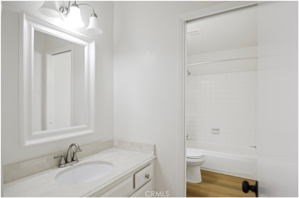1110 Redding Avenue Costa Mesa, CA 92626 - Photo 13 of 30 a bathroom with a granite countertop sink toilet and shower