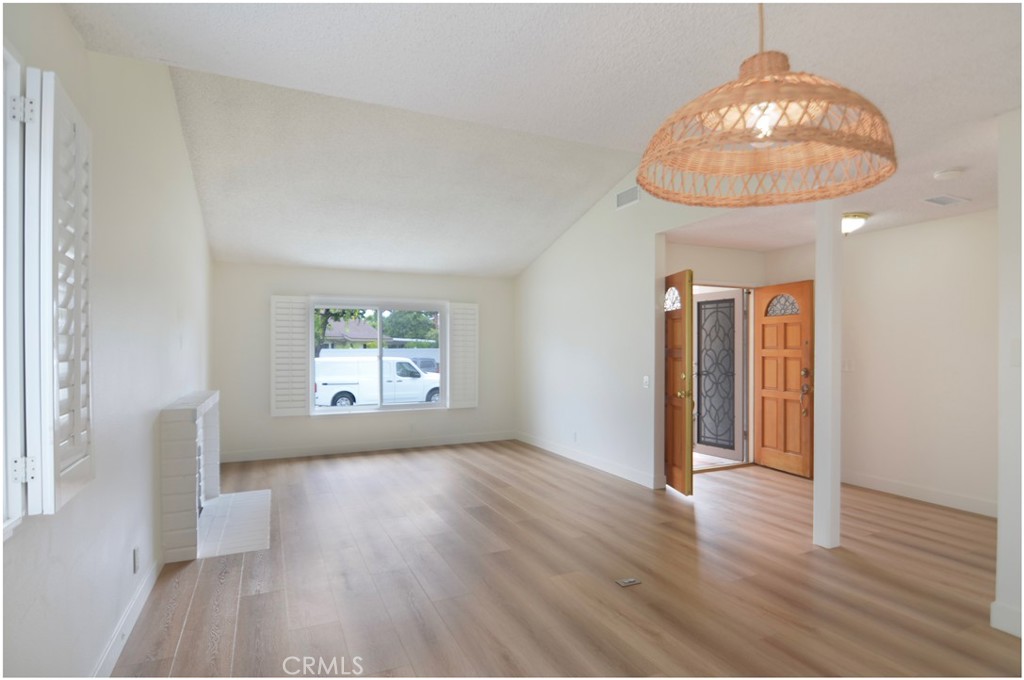 1110 Redding Avenue Costa Mesa, CA 92626 - Photo 5 of 30 an empty room with wooden floor and windows