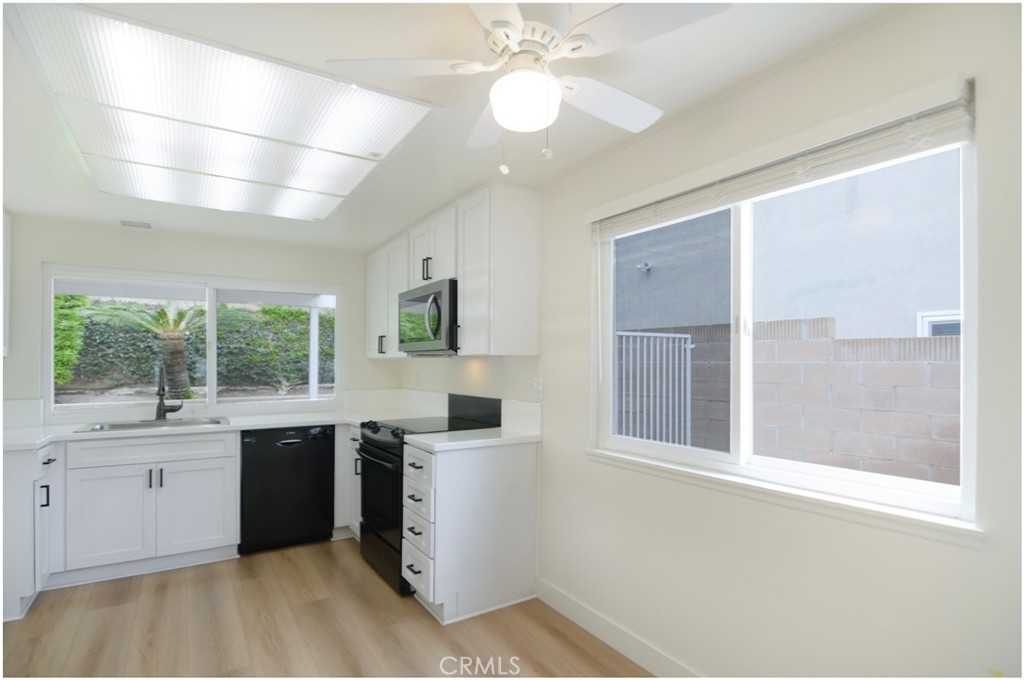 1110 Redding Avenue Costa Mesa, CA 92626 - Photo 7 of 30 a kitchen with a sink window and cabinets