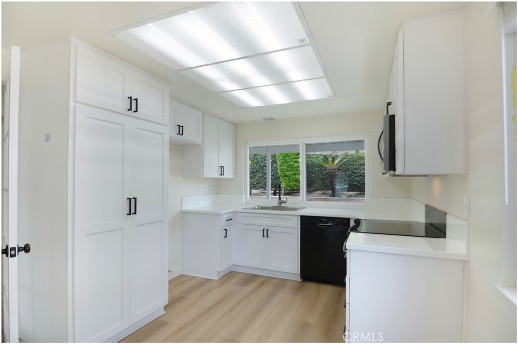 1110 Redding Avenue Costa Mesa, CA 92626 - Photo 8 of 30 a kitchen with cabinets and wooden floor