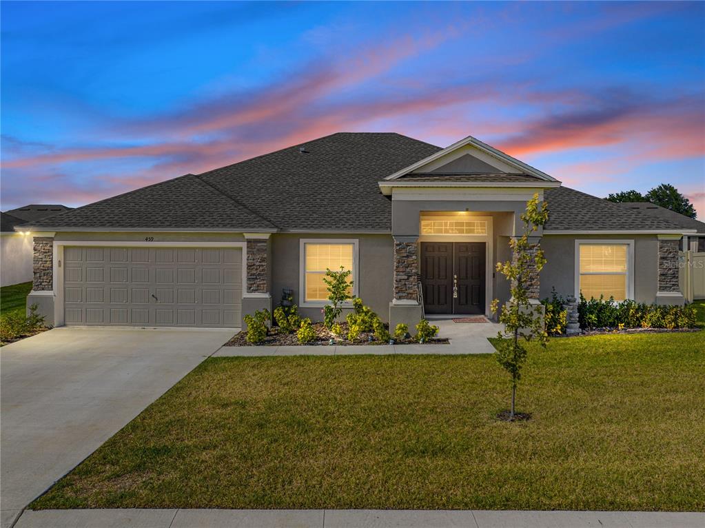 a front view of a house with a yard