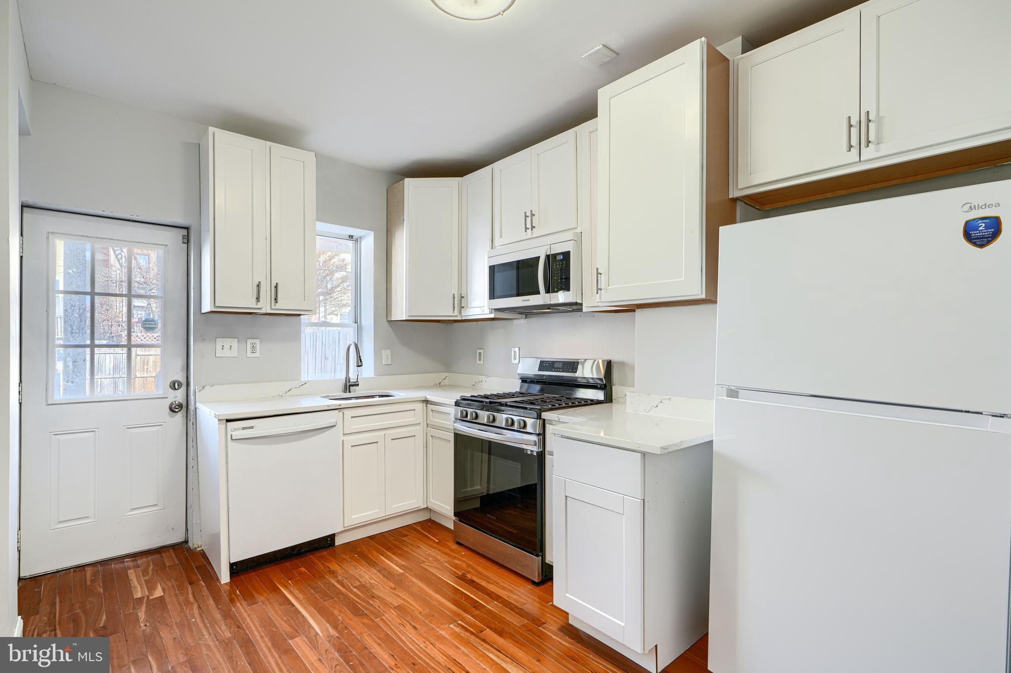 2511 McCulloh Street Baltimore, MD 21217 - Photo 12 of 32 a kitchen with stainless steel appliances granite countertop a stove a sink and a refrigerator