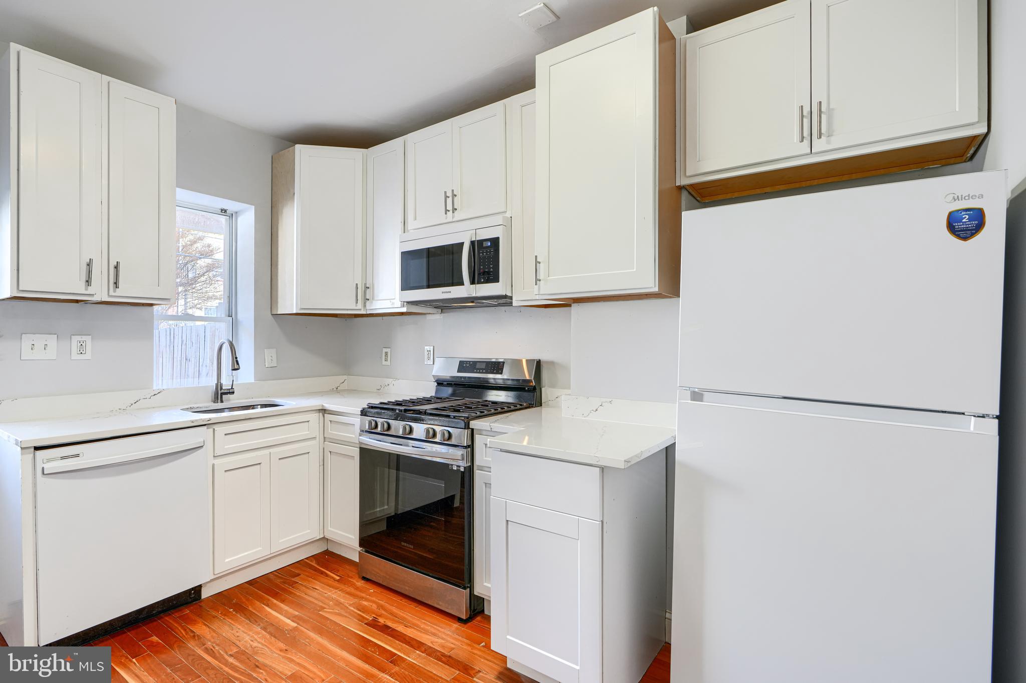 2511 McCulloh Street Baltimore, MD 21217 - Photo 15 of 35 a kitchen with stainless steel appliances granite countertop white cabinets sink and a refrigerator