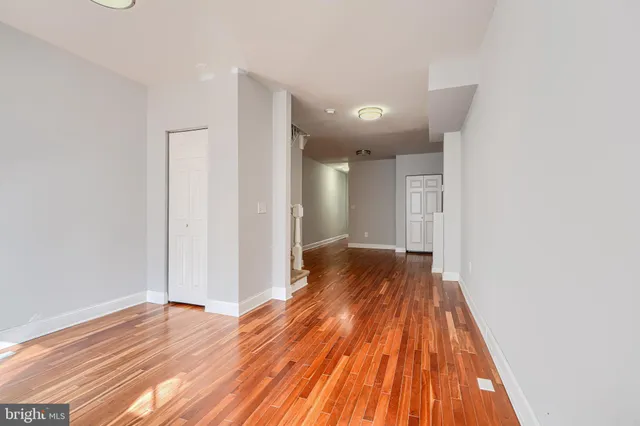 a view of hallway with wooden floor