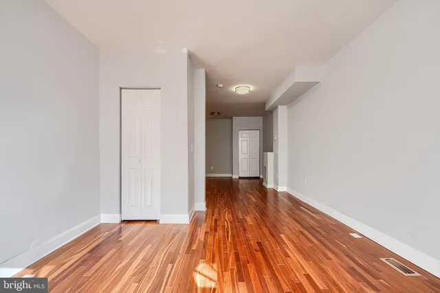 a view of an empty room and wooden floor