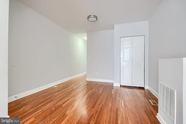 a view of a room with wooden floor and white doors