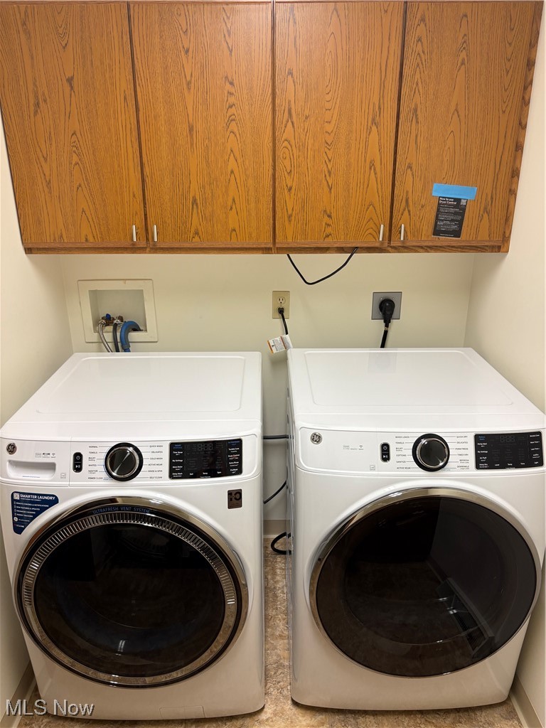 6695 Clingan Road, Unit 24 Youngstown, OH 44514 - Photo 9 of 26 Washroom featuring cabinet space and washer and dryer