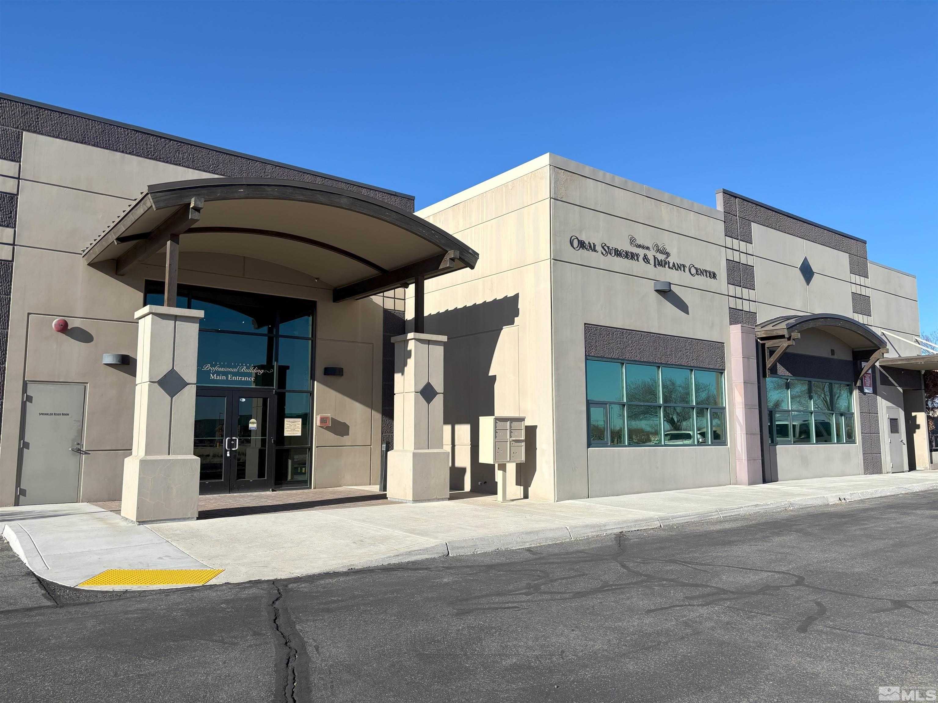 a view of a building with car parked