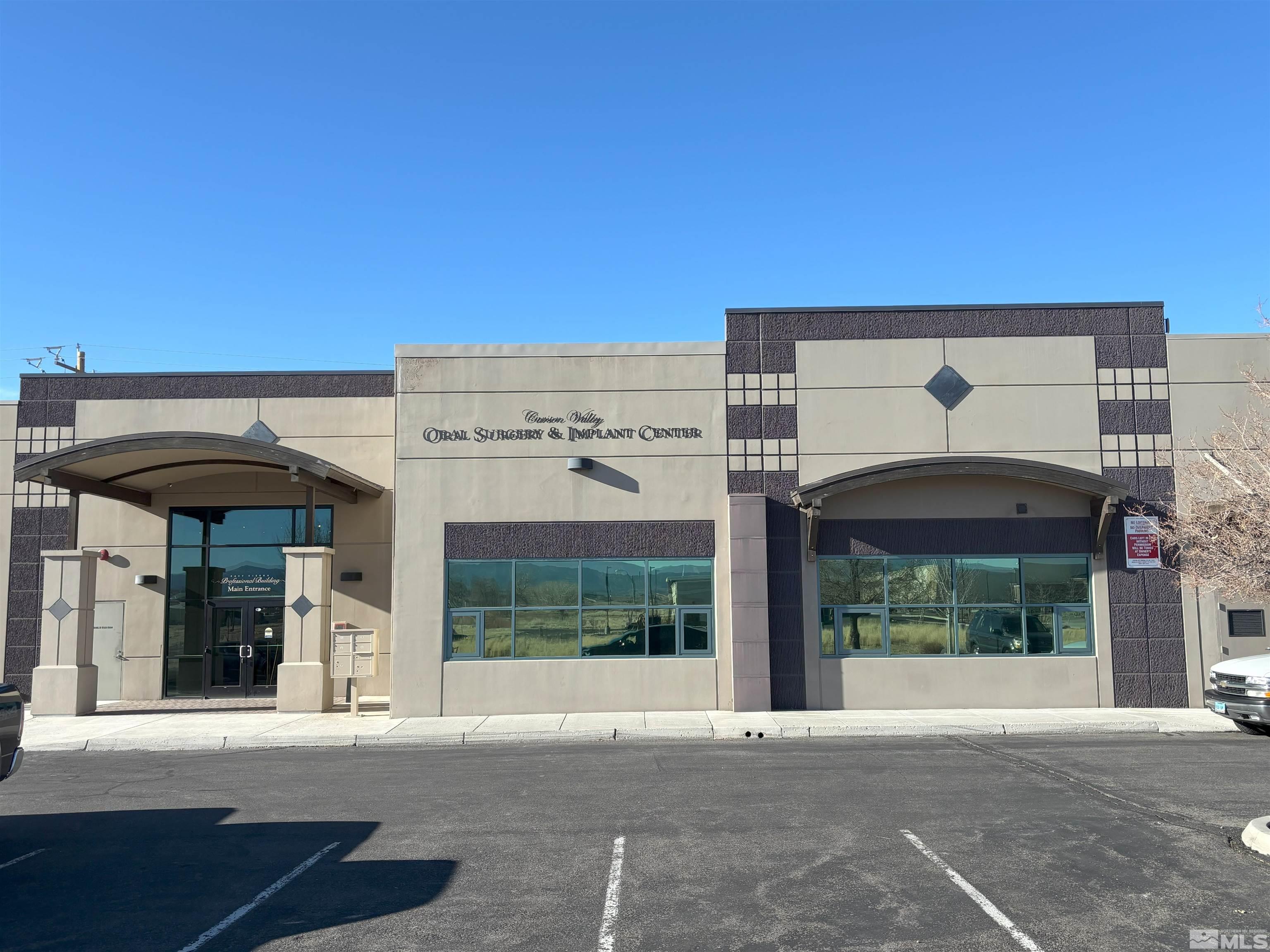 1516 Charlotte Way, Unit B Gardnerville, NV 89410 - Photo 3 of 17 a front view of a building with a garden
