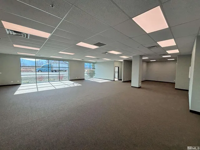 a view of a hall with wooden floor