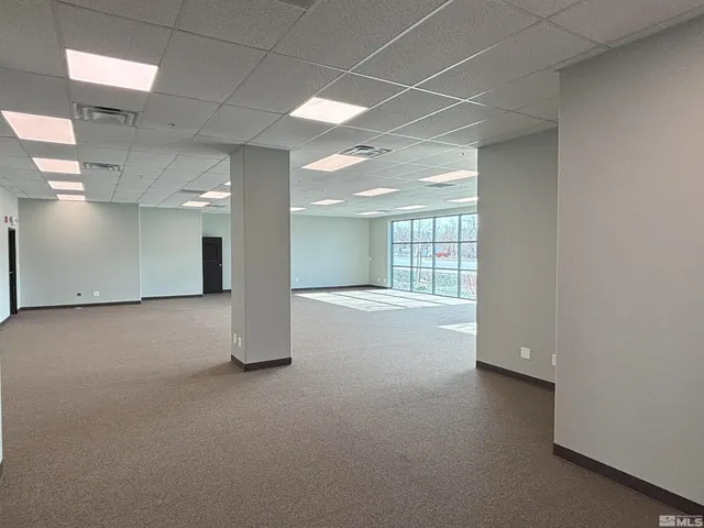 an empty room with a empty space and windows