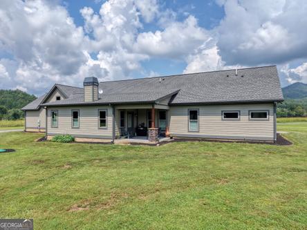 186 Rice Landing Hayesville, NC 28904 - Photo 12 of 77 a view of a house with a garden and yard