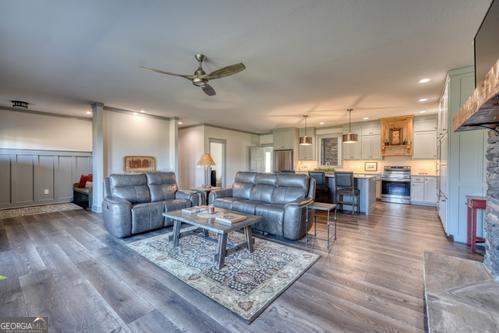 186 Rice Landing Hayesville, NC 28904 - Photo 38 of 77 a living room with lots of furniture and a dining table with wooden floor