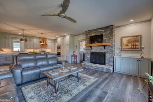 186 Rice Landing Hayesville, NC 28904 - Photo 39 of 77 a living room with furniture a flat screen tv and a fireplace