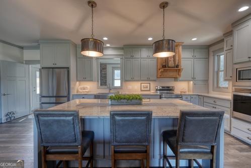 186 Rice Landing Hayesville, NC 28904 - Photo 40 of 77 a kitchen with kitchen island granite countertop a table and chairs in it