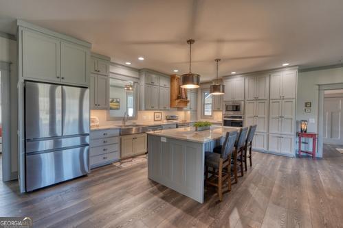 186 Rice Landing Hayesville, NC 28904 - Photo 41 of 77 a kitchen with stainless steel appliances kitchen island granite countertop a refrigerator a oven a stove and a wooden floors