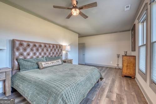 186 Rice Landing Hayesville, NC 28904 - Photo 56 of 77 a bedroom with a large bed and a chandelier