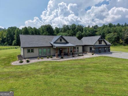 186 Rice Landing Hayesville, NC 28904 - Photo 7 of 77 a view of a big house with a big yard and large trees