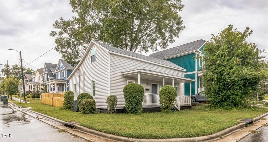 1512 Pender Street Raleigh, NC 27610 - Photo 1 of 12 a view of a white house with a small yard and plants