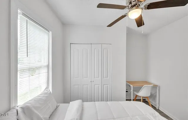 a bedroom with a bed and a window