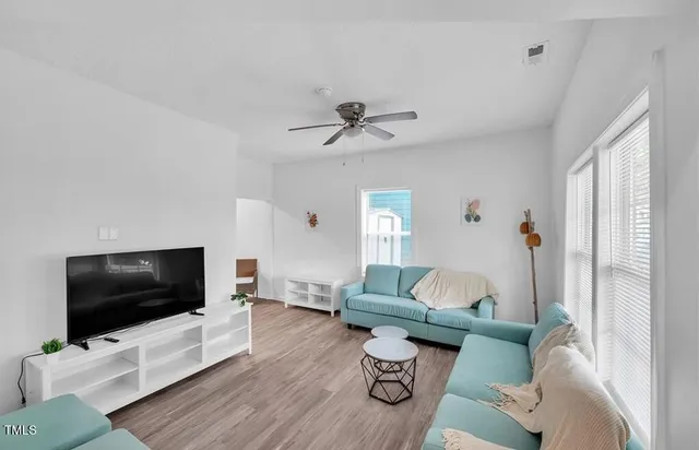 a living room with furniture and a flat screen tv