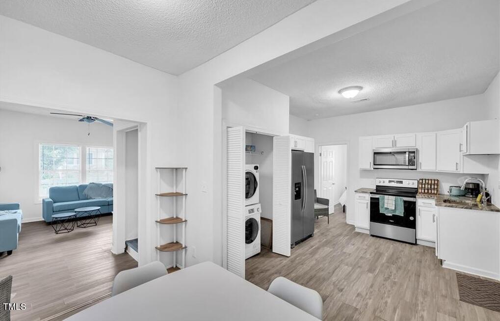 1512 Pender Street Raleigh, NC 27610 - Photo 6 of 12 a living room with stainless steel appliances furniture and a view of kitchen